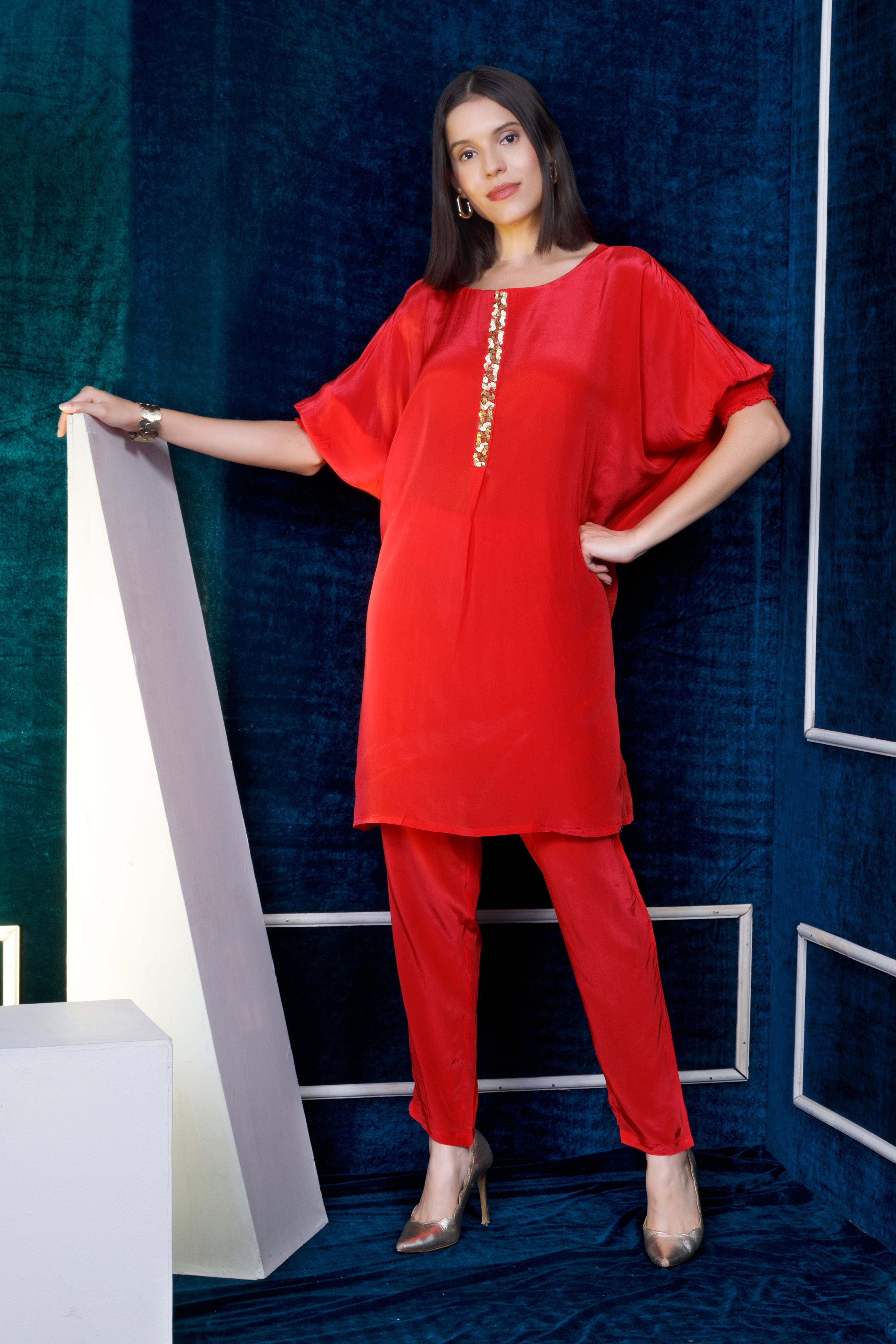 Coral crepe kurta with gold embroidery on kurta Patti  teamed with straight pants