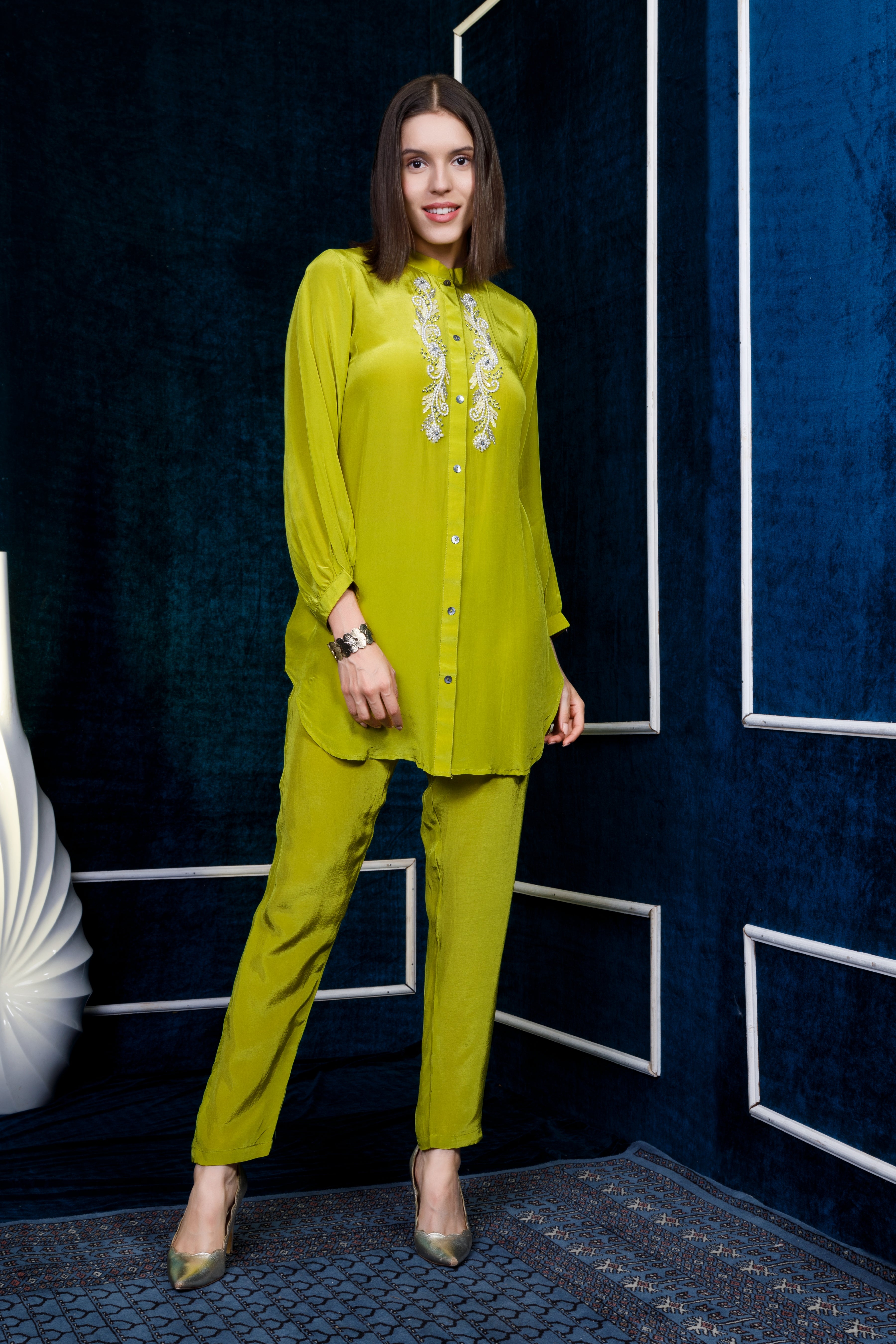 Green crepe kurta with intricate pearl embroidery teamed with straight pants