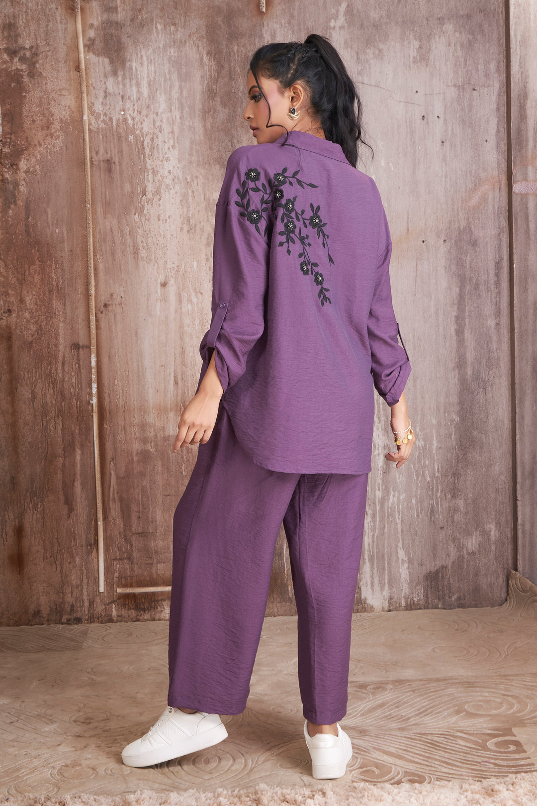 Purple shirt with black thread and stone work in front and back teamed with palazzo pants