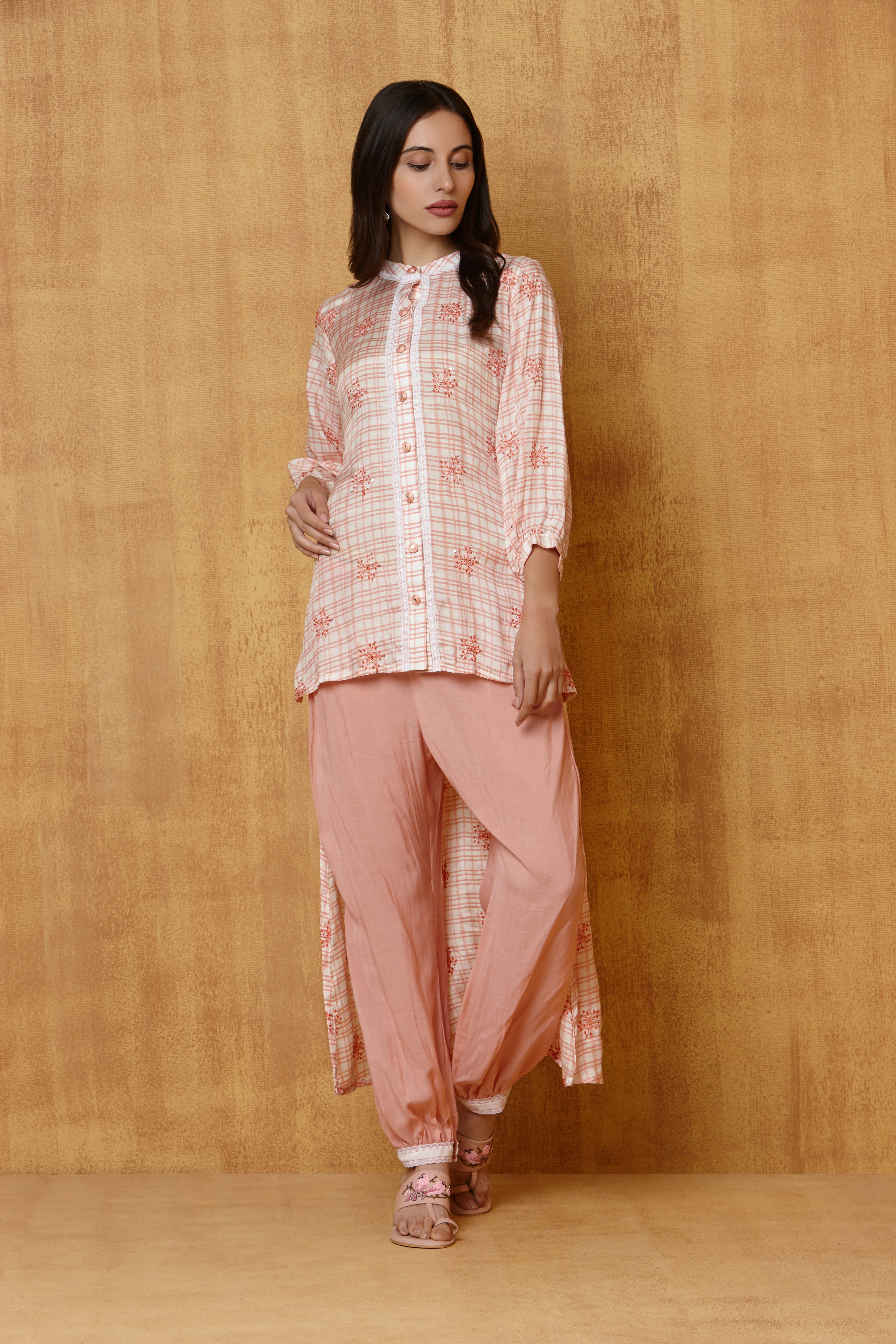 Peach & white checks print short long kurta with emb motif and lace detailing teamed with plain jogger pants with lace trim on the bottom